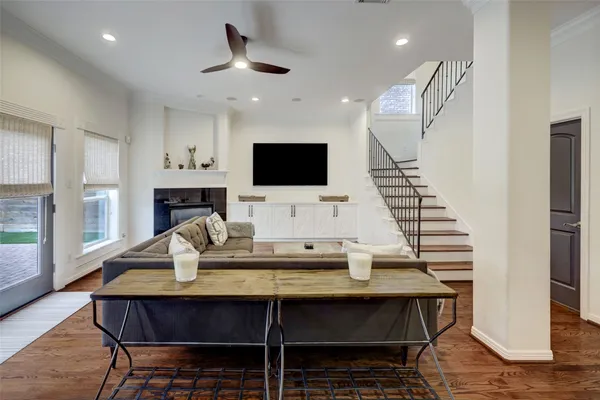 a living room with furniture a fireplace and a flat screen tv