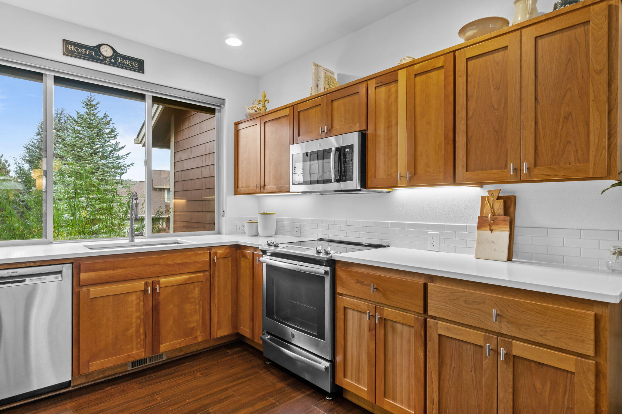 10942 Village Loop Redmond, OR 97756 - Photo 13 of 45 a kitchen with stainless steel appliances granite countertop a sink a stove and cabinets