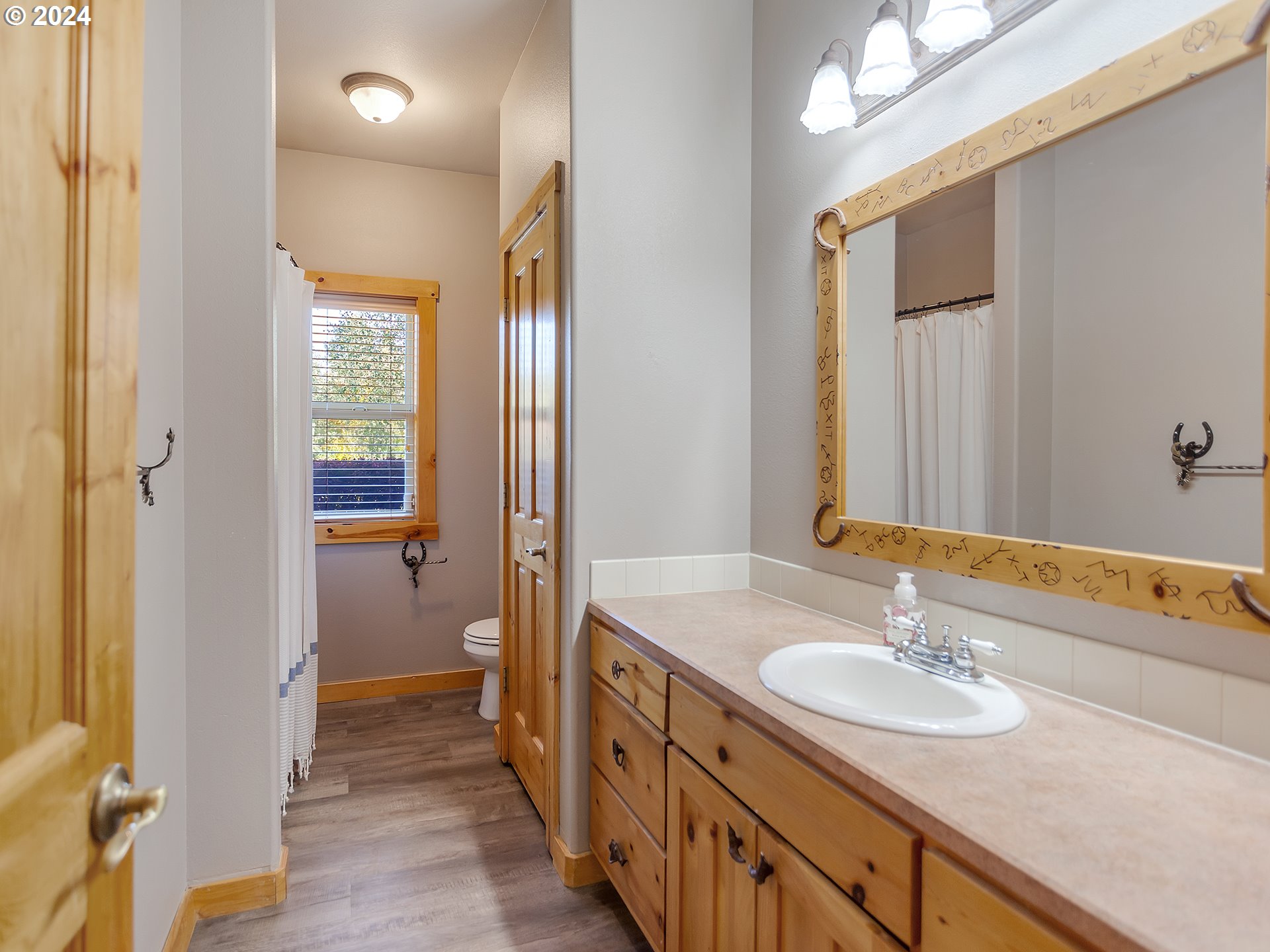 30410 Northwest 18th Place Ridgefield, WA 98642 - Photo 21 of 43 a bathroom with a sink a mirror and a shower