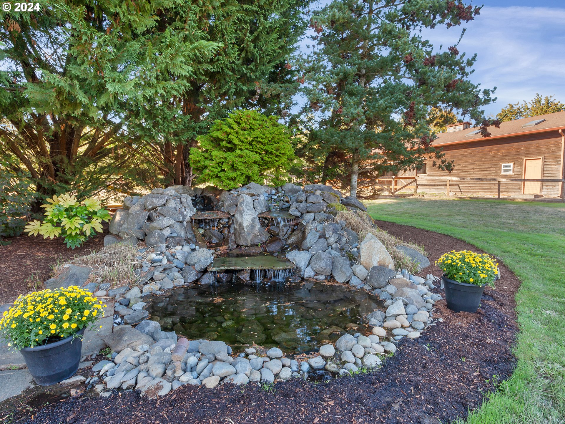 30410 Northwest 18th Place Ridgefield, WA 98642 - Photo 41 of 43 a view of a garden with a bench