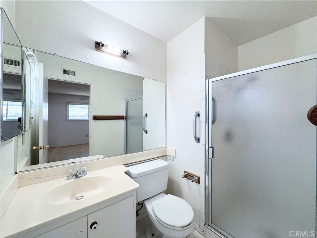 20722 Devonshire Street Chatsworth, CA 91311 - Photo 14 of 20 a bathroom with a sink a toilet and shower