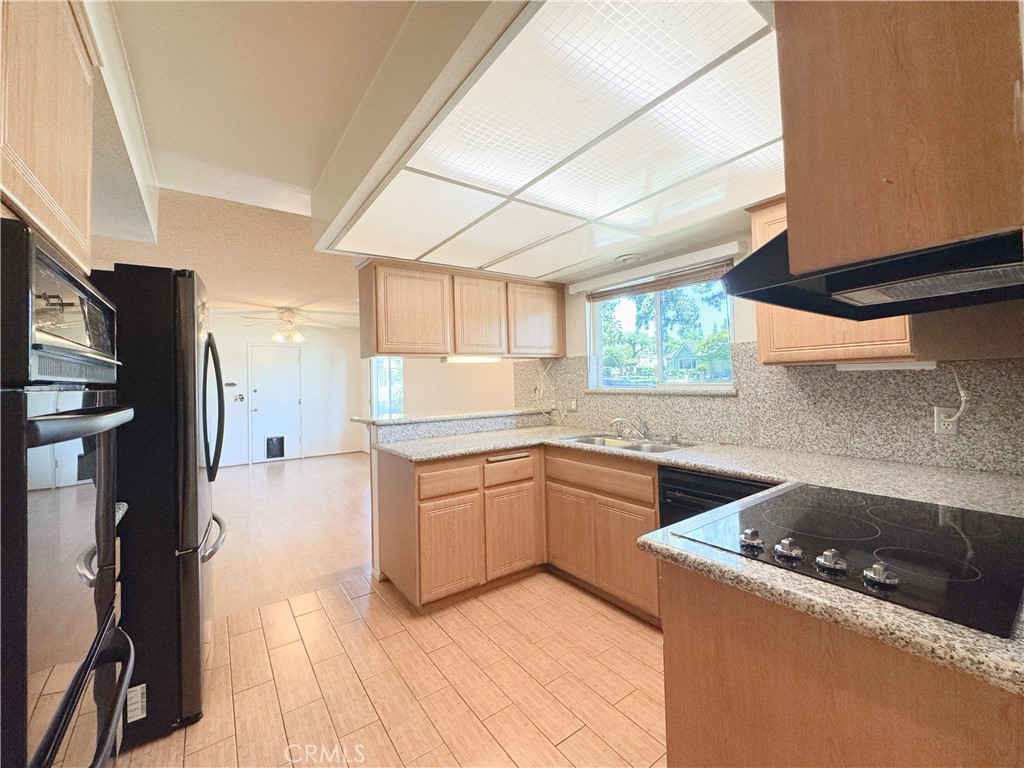 20722 Devonshire Street Chatsworth, CA 91311 - Photo 2 of 20 a kitchen with a sink stove and refrigerator