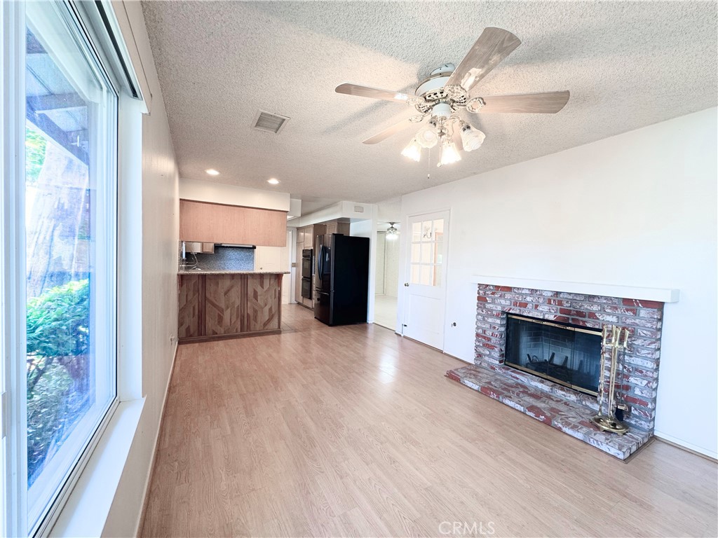 20722 Devonshire Street Chatsworth, CA 91311 - Photo 4 of 20 a view of a room with kitchen and fireplace
