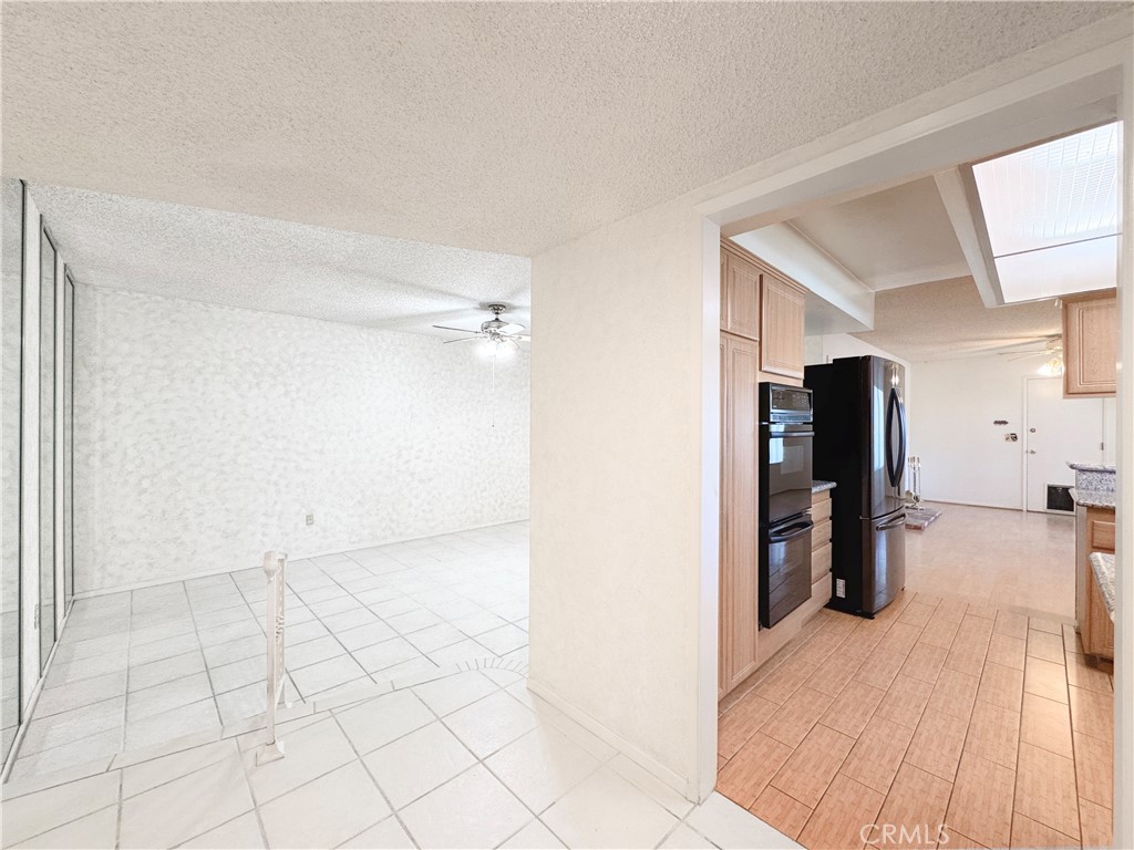 20722 Devonshire Street Chatsworth, CA 91311 - Photo 8 of 20 a view of a kitchen with a sink and a refrigerator