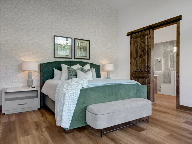 a bedroom with a bed and a night stand