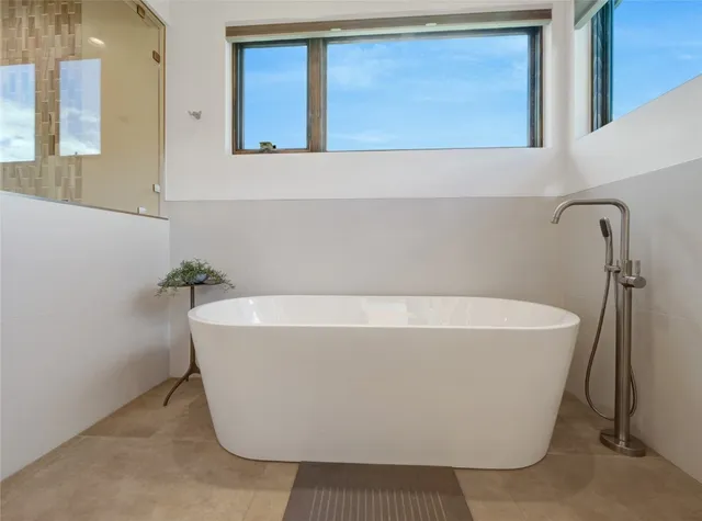 a white bath tub sitting in a bathroom