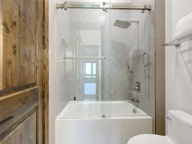 a bathroom with a tub and a shower