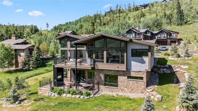 a view of a house with a yard balcony and furniture