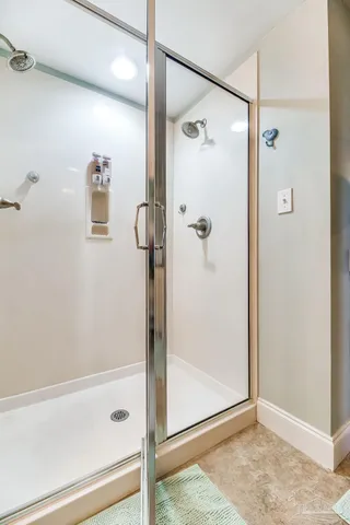 a bathroom with a granite countertop toilet sink and mirror