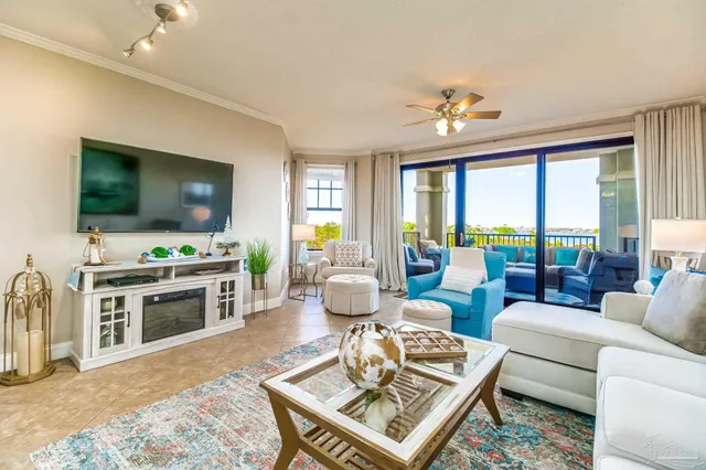 a living room with furniture a chandelier and a dining table