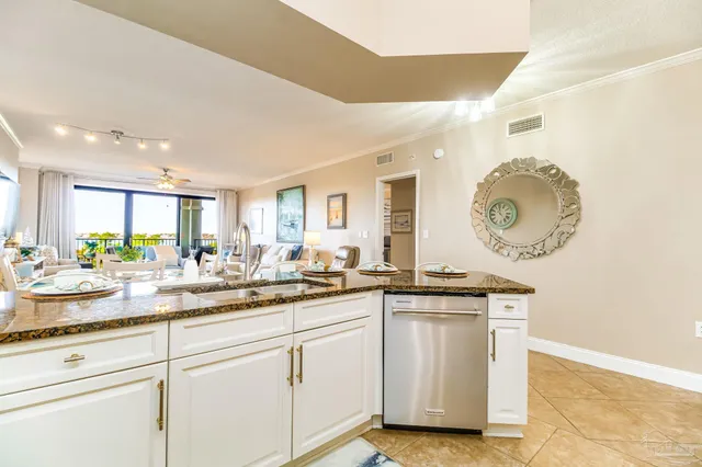 a kitchen with white cabinets and refrigerator