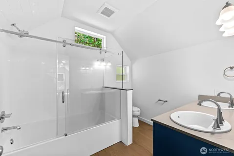 an empty room with wooden floor and stairs