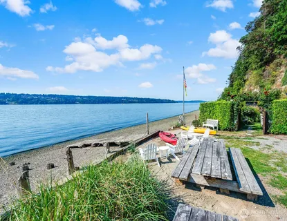 a view of a balcony with wooden floor and lake view