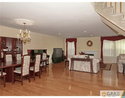 4504 Stonehedge Road Edison, NJ 08820 - Photo 2 of 16 a living room with furniture and a wooden floor