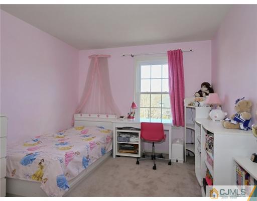 4504 Stonehedge Road Edison, NJ 08820 - Photo 11 of 16 a bedroom with a bed and a window