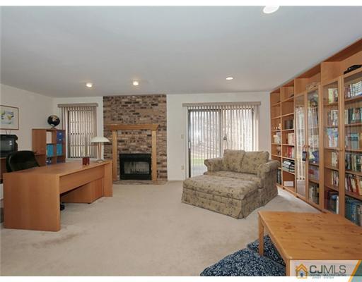 4504 Stonehedge Road Edison, NJ 08820 - Photo 13 of 16 a living room with furniture and a fireplace