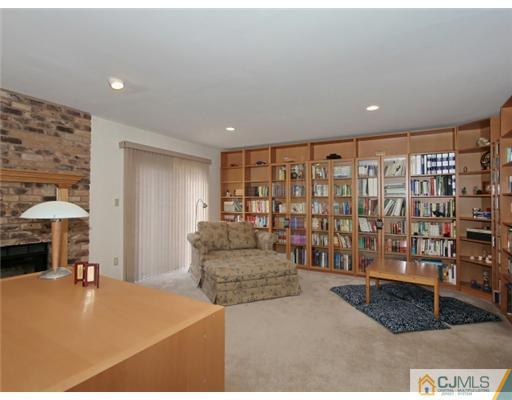 4504 Stonehedge Road Edison, NJ 08820 - Photo 14 of 16 a living room with a couch and chandelier