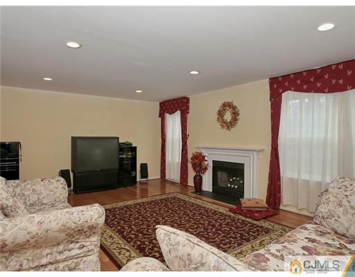 4504 Stonehedge Road Edison, NJ 08820 - Photo 3 of 16 a living room with furniture and a fireplace