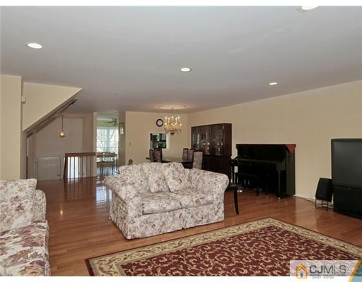 4504 Stonehedge Road Edison, NJ 08820 - Photo 4 of 16 a living room with furniture rug and a table