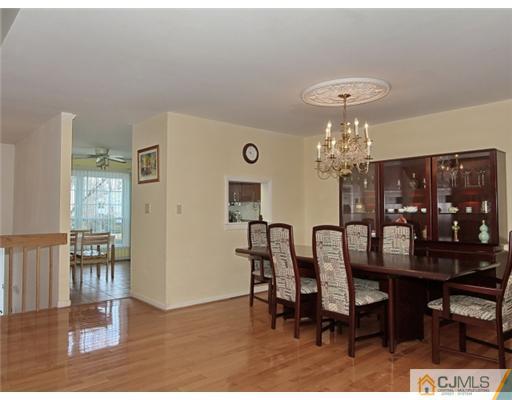 4504 Stonehedge Road Edison, NJ 08820 - Photo 5 of 16 a view of a dining room with furniture and chandelier