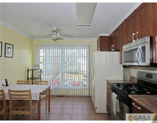 4504 Stonehedge Road Edison, NJ 08820 - Photo 6 of 16 a kitchen with stainless steel appliances granite countertop a stove a refrigerator and a dining table
