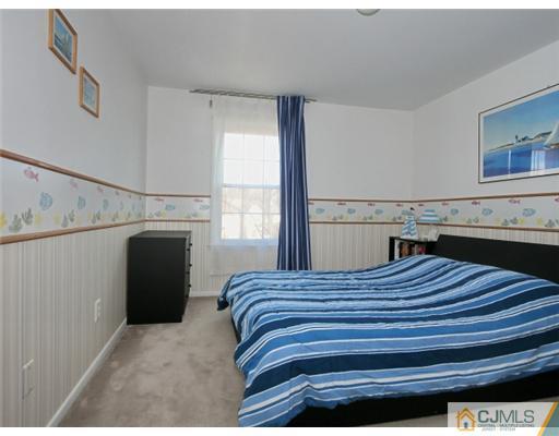 4504 Stonehedge Road Edison, NJ 08820 - Photo 10 of 16 a bedroom with a bed and a window