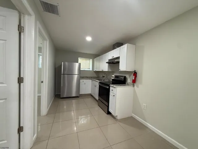 a kitchen with appliances cabinets and a sink