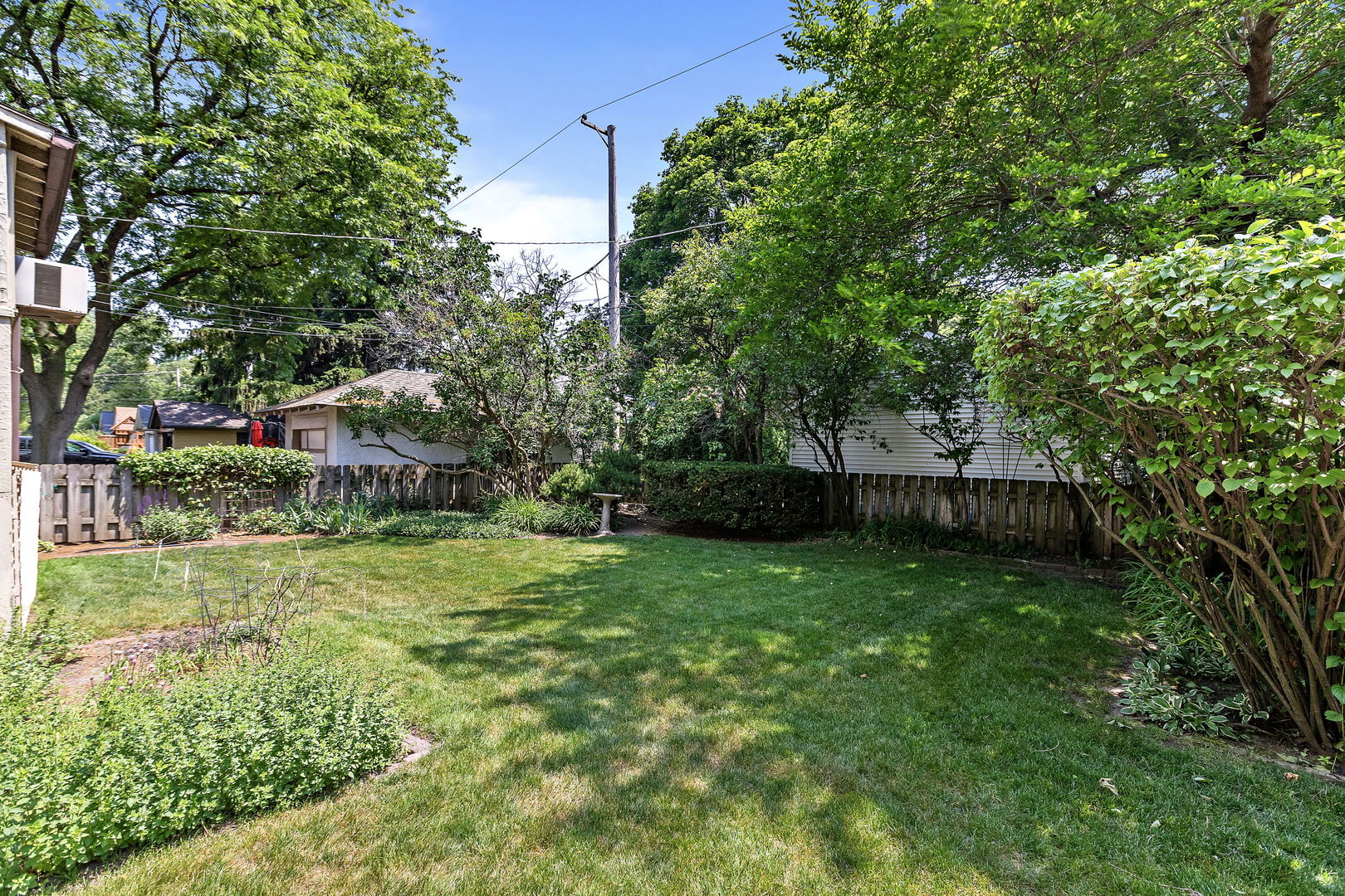 106 4th Street Wilmette, IL 60091 - Photo 19 of 20 a view of a backyard with plants and large trees