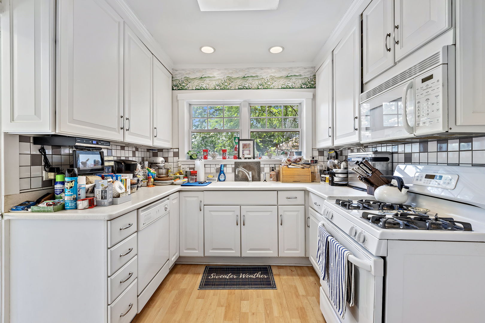 106 4th Street Wilmette, IL 60091 - Photo 6 of 20 a kitchen with a white cabinets and white appliances