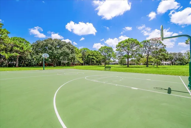 a view of a playground with basketball court