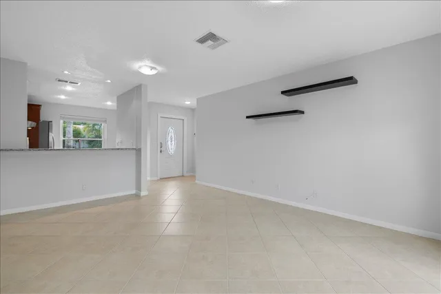 an empty room with a empty space and windows