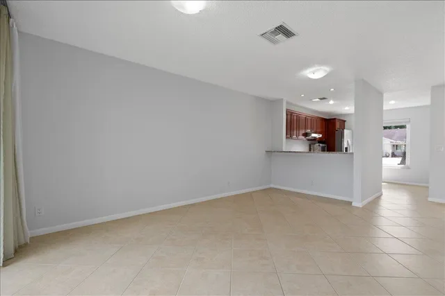 an empty room with a kitchen and a sink