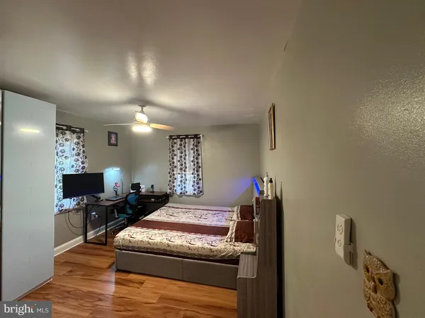 a bedroom with furniture and a wooden floor