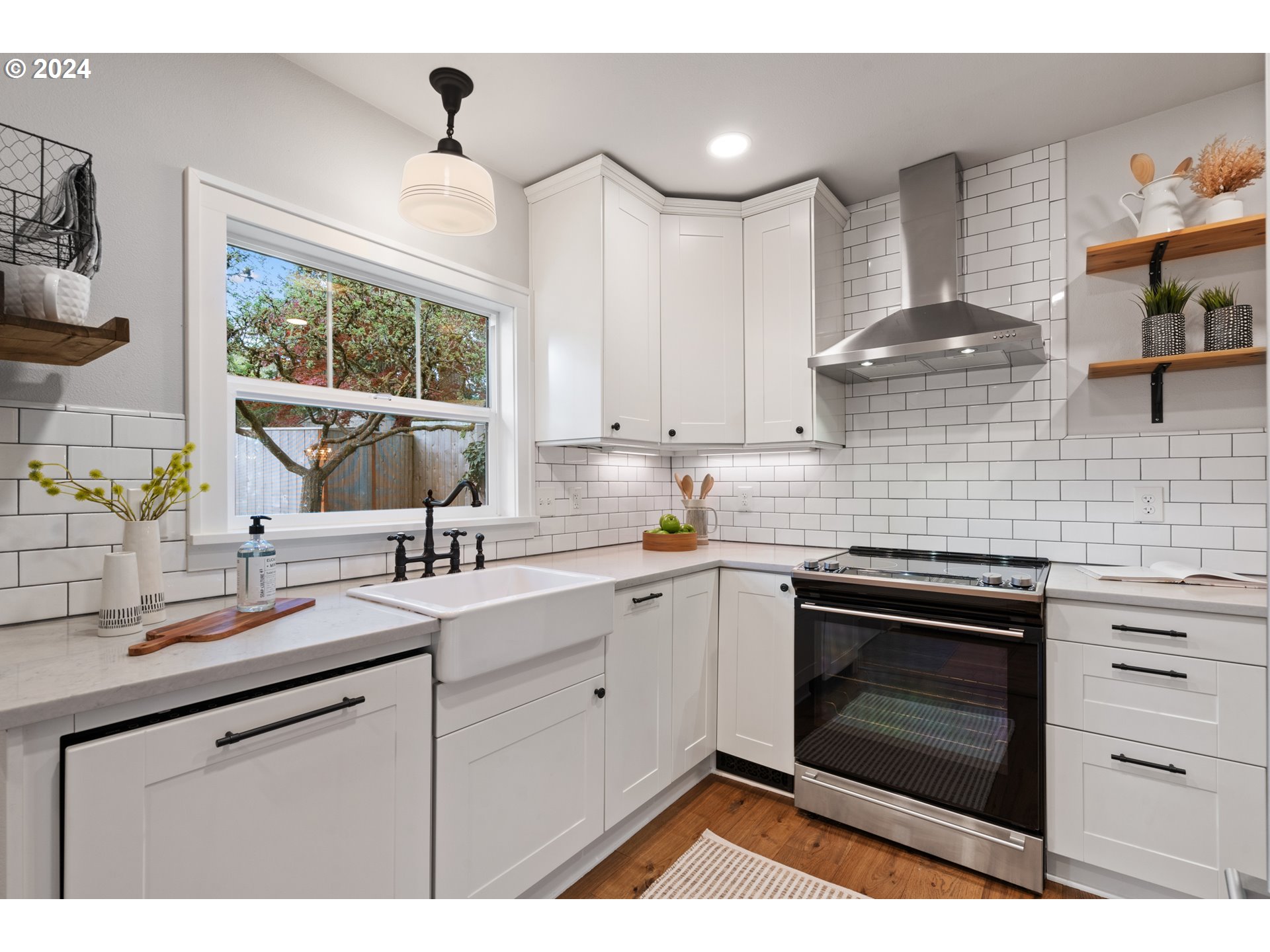 4016 Southwest Cullen Boulevard Portland, OR 97221 - Photo 11 of 41 a kitchen with a sink stove and cabinets
