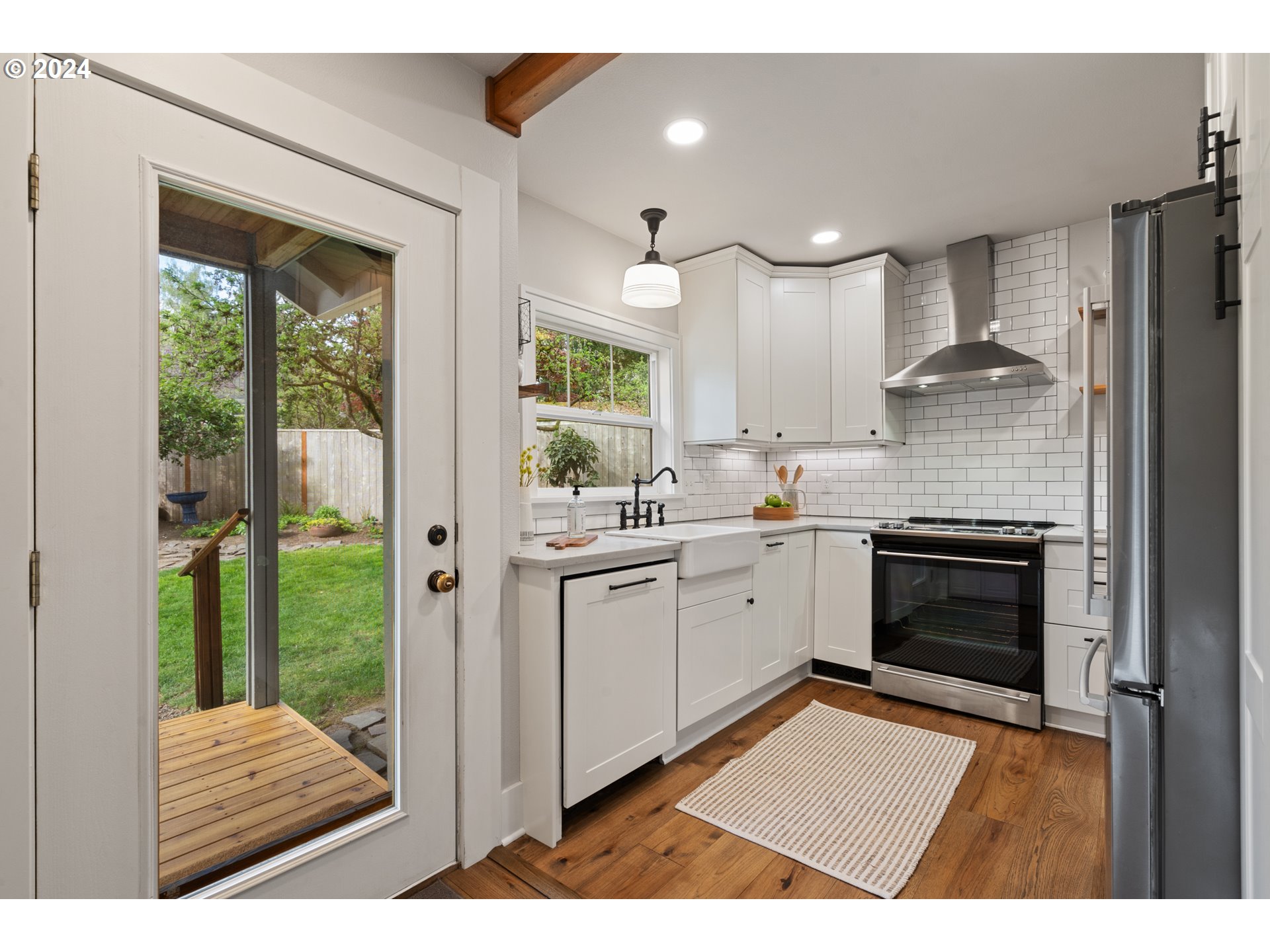 4016 Southwest Cullen Boulevard Portland, OR 97221 - Photo 12 of 41 a open kitchen with white cabinets and wooden floor