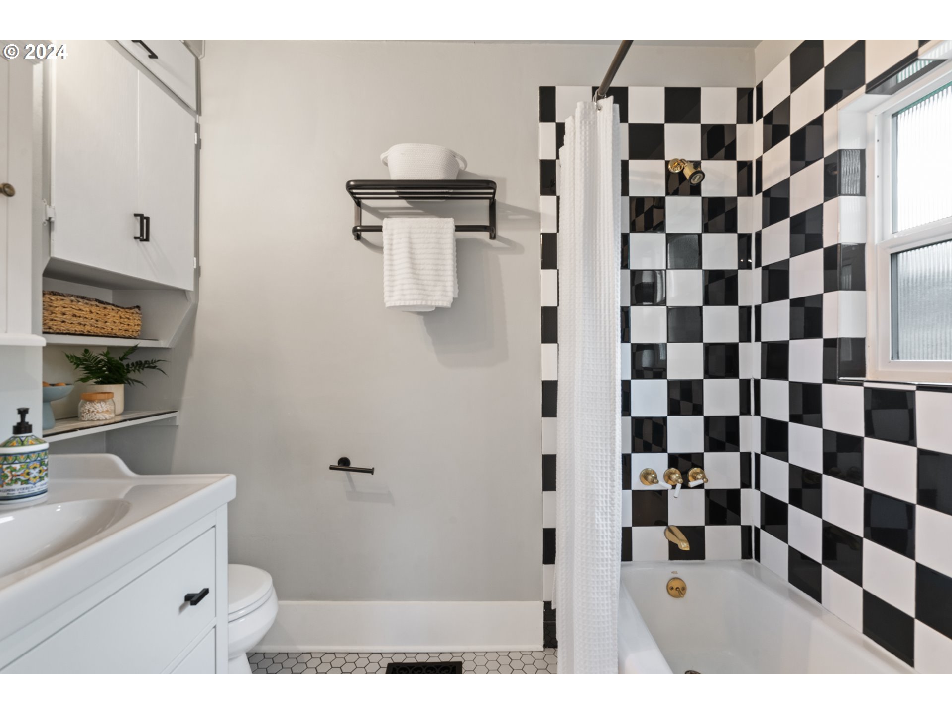 4016 Southwest Cullen Boulevard Portland, OR 97221 - Photo 29 of 41 a bathroom with a sink a toilet and a mirror