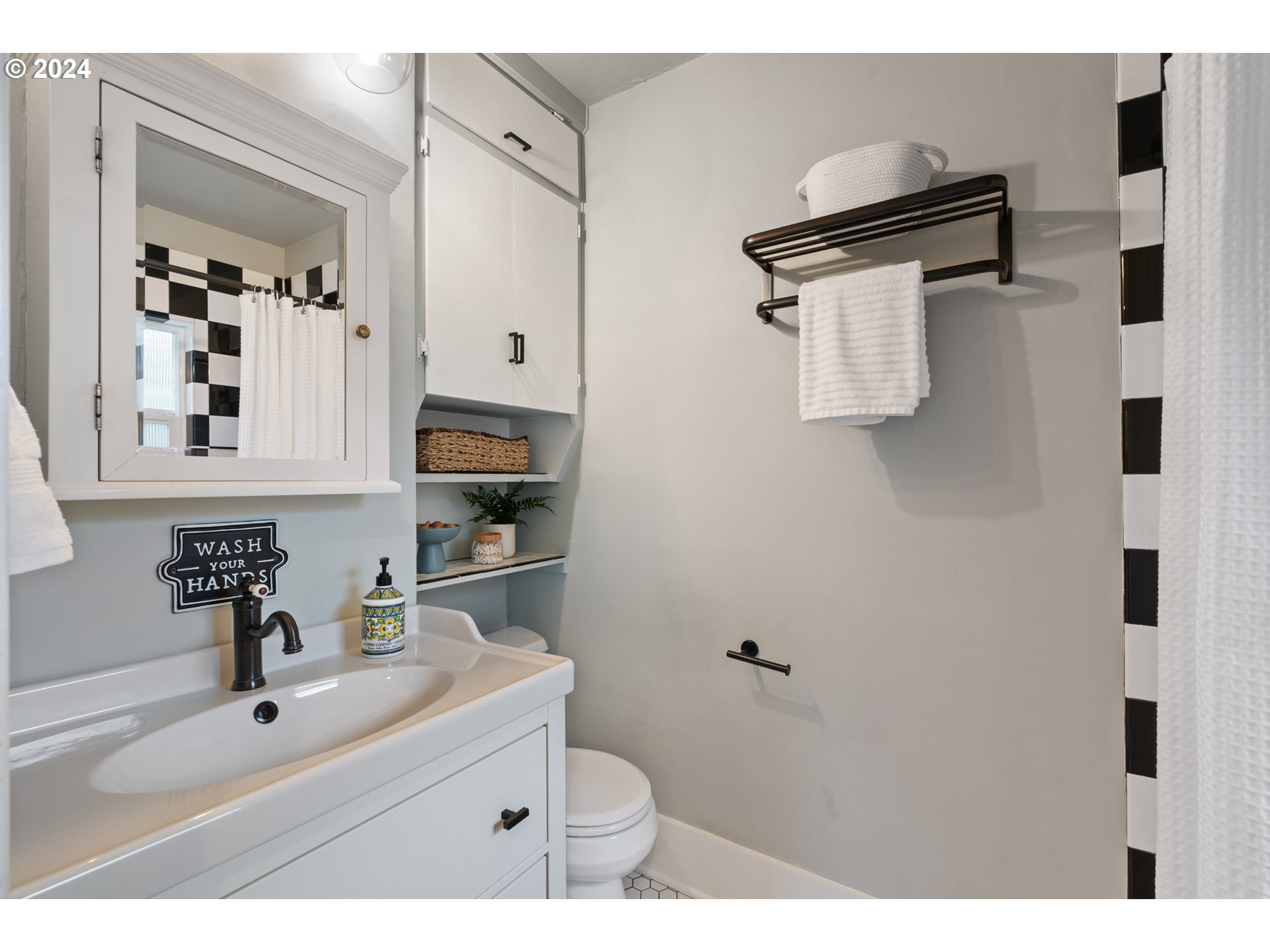 4016 Southwest Cullen Boulevard Portland, OR 97221 - Photo 30 of 41 a bathroom with a sink toilet and mirror