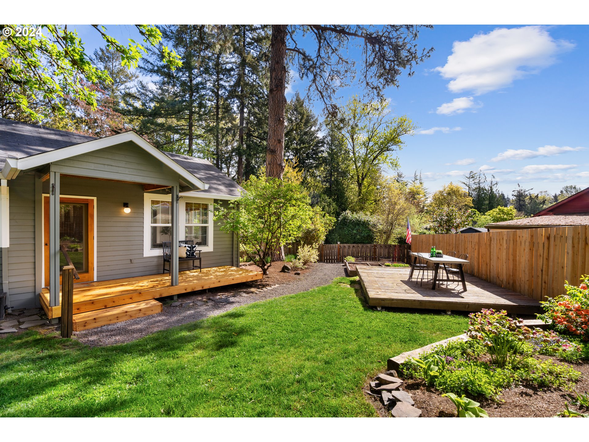 4016 Southwest Cullen Boulevard Portland, OR 97221 - Photo 33 of 41 a view of a house with backyard sitting area and garden