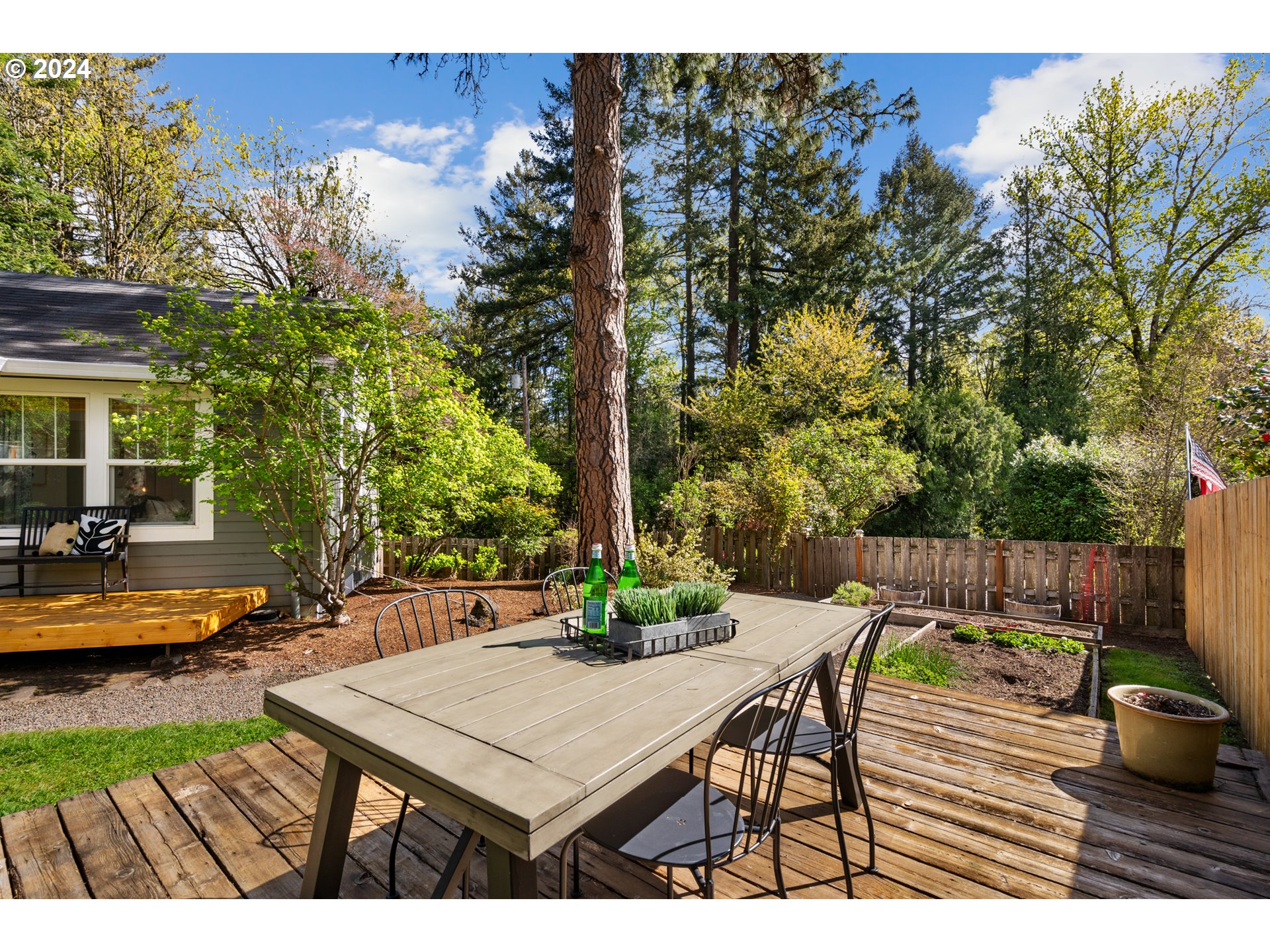 4016 Southwest Cullen Boulevard Portland, OR 97221 - Photo 36 of 41 a view of a patio with table and chairs potted plants with wooden floor