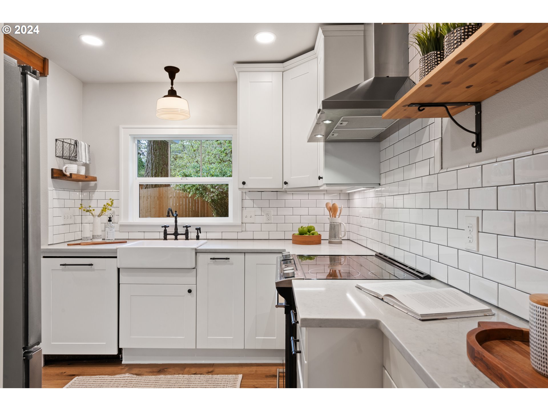 4016 Southwest Cullen Boulevard Portland, OR 97221 - Photo 9 of 41 a kitchen that has a sink and a stove in it