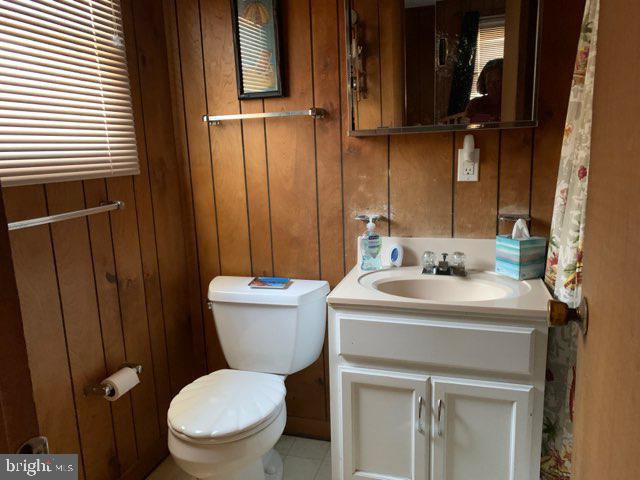 607 Collins Street Bethany Beach, DE 19930 - Photo 12 of 13 a bathroom with a toilet sink and mirror