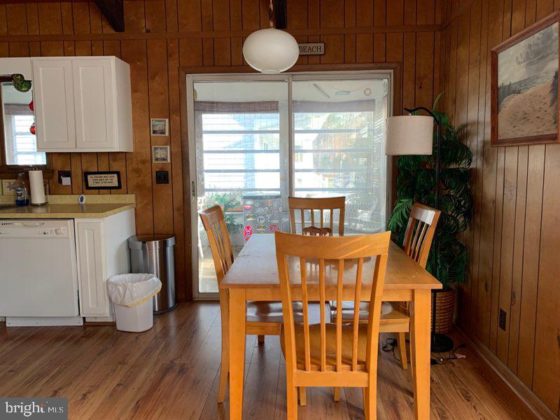 607 Collins Street Bethany Beach, DE 19930 - Photo 6 of 13 a view of a dining room with furniture window and wooden floor