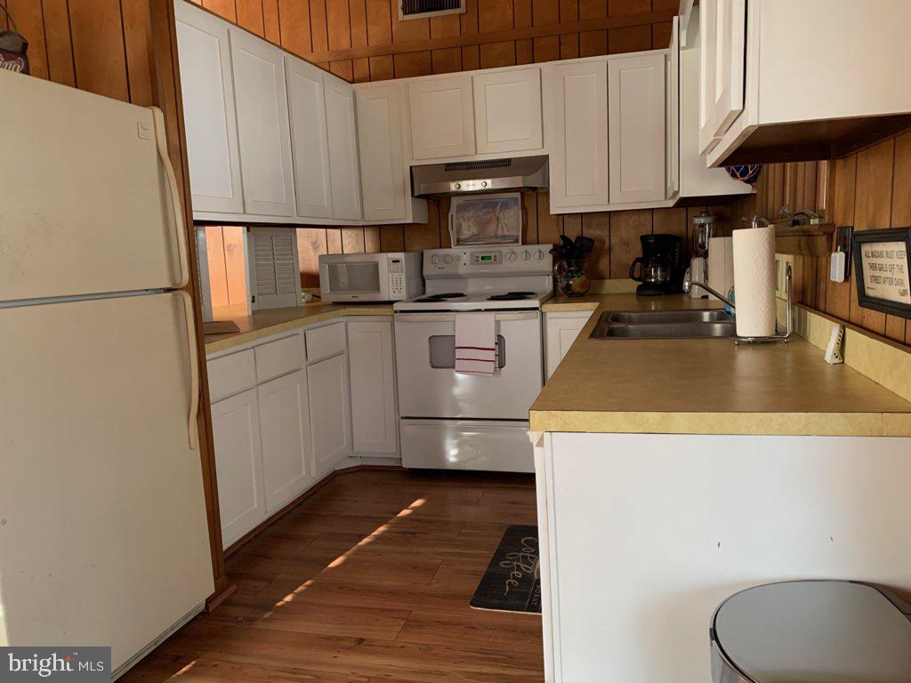 607 Collins Street Bethany Beach, DE 19930 - Photo 8 of 13 a kitchen with a sink a stove and refrigerator