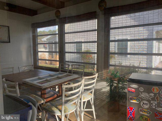 607 Collins Street Bethany Beach, DE 19930 - Photo 9 of 13 a view of a dining room with furniture and a window