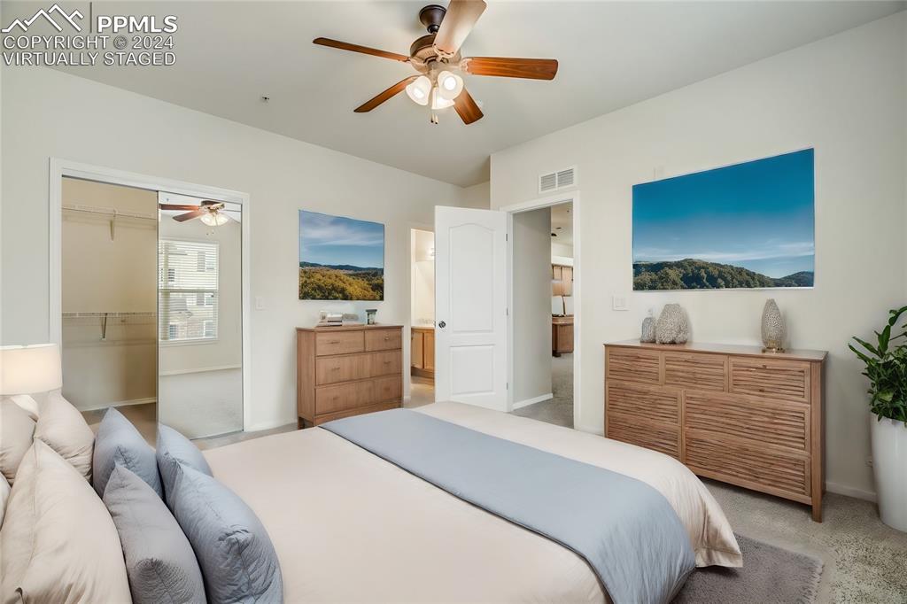 5353 Palomino Ranch Point, Unit 202 Colorado Springs, CO 80922 - Photo 19 of 34 a bedroom with a bed and a dresser