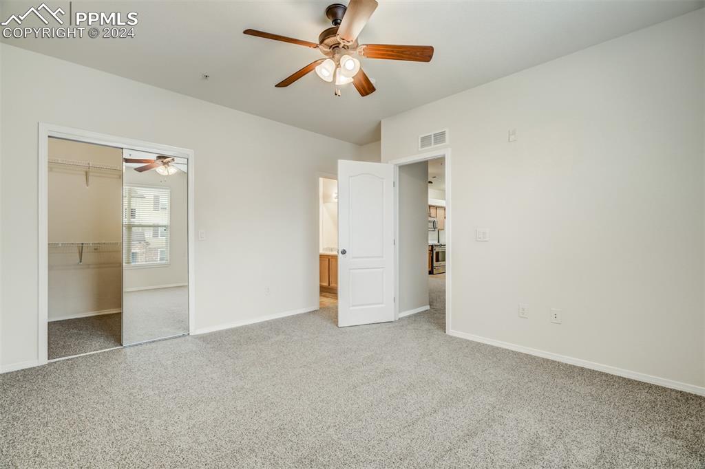 5353 Palomino Ranch Point, Unit 202 Colorado Springs, CO 80922 - Photo 20 of 34 an empty room with closet and a ceiling fan