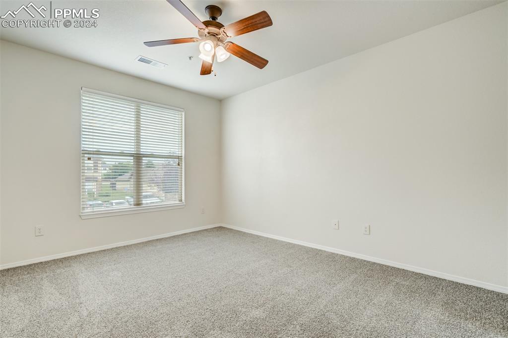 5353 Palomino Ranch Point, Unit 202 Colorado Springs, CO 80922 - Photo 22 of 34 an empty room with a window and a fan