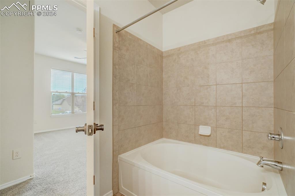 5353 Palomino Ranch Point, Unit 202 Colorado Springs, CO 80922 - Photo 24 of 34 a white bath tub sitting in a bathroom