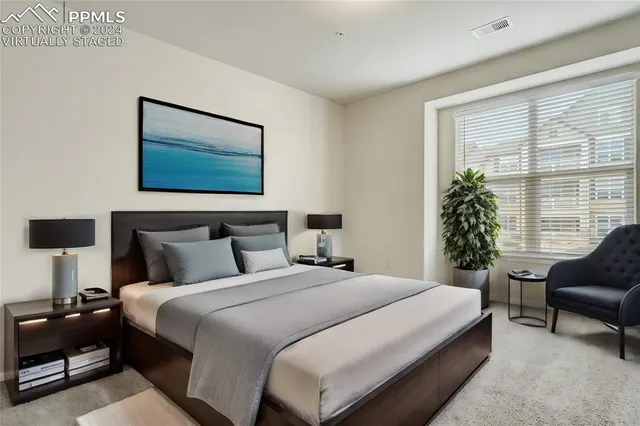 a bedroom with bed and a potted plant