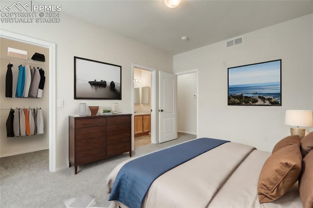 5353 Palomino Ranch Point, Unit 202 Colorado Springs, CO 80922 - Photo 28 of 34 a bedroom with a bed and a flat screen tv